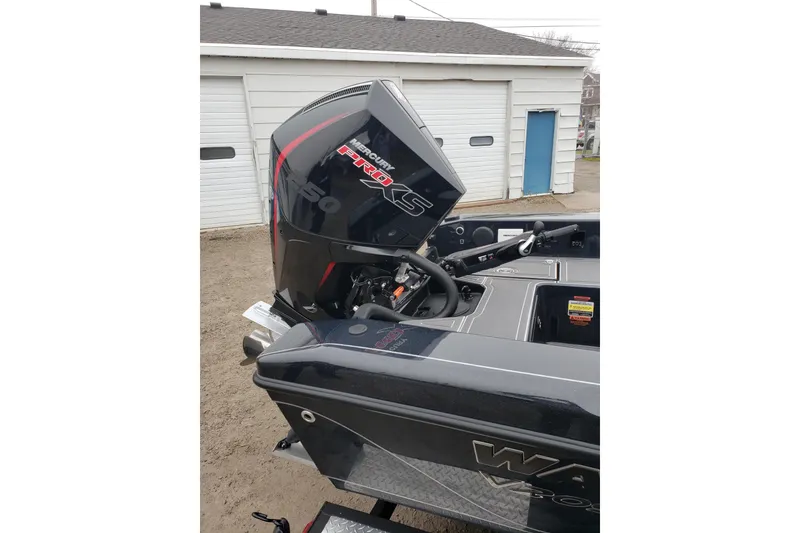 Slide: The Image of 2026 Warrior V2090 boat with Mercury Pro XS engine in a garage setting. - 10