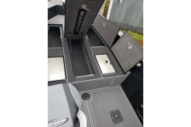 Slide: The Image of 2026 Warrior V2090 boat storage compartments with open lids, showcasing interior space. - 7