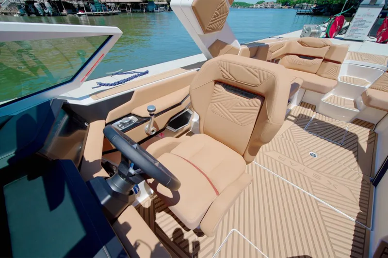 Slide: The Image of Luxurious interior of 2025 MasterCraft XStar 25 boat with tan seating and modern controls. - 11