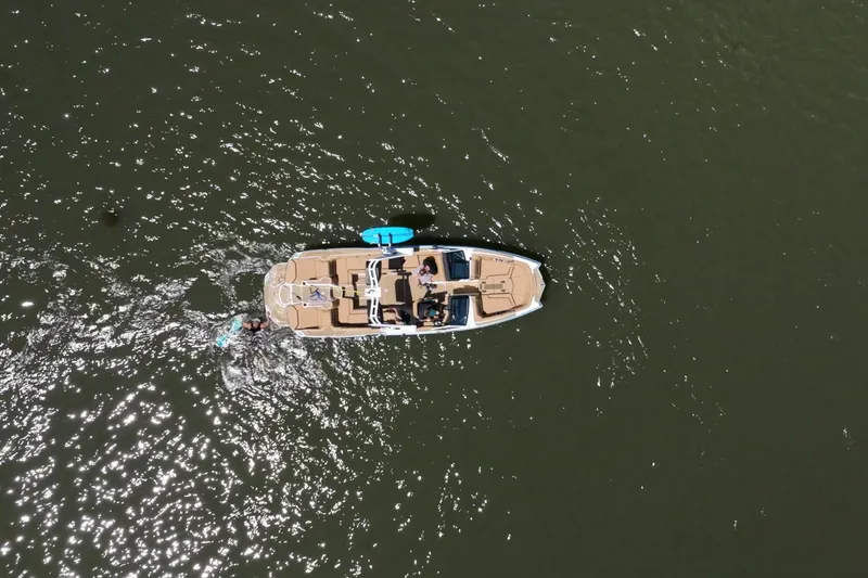 Slide: The Image of Aerial view of 2025 MasterCraft XStar 25 boat on water with passengers. - 6