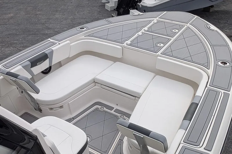 Slide: The Image of 2023 Robalo 266 Cayman boat interior with cushioned seating and storage compartments. - 17
