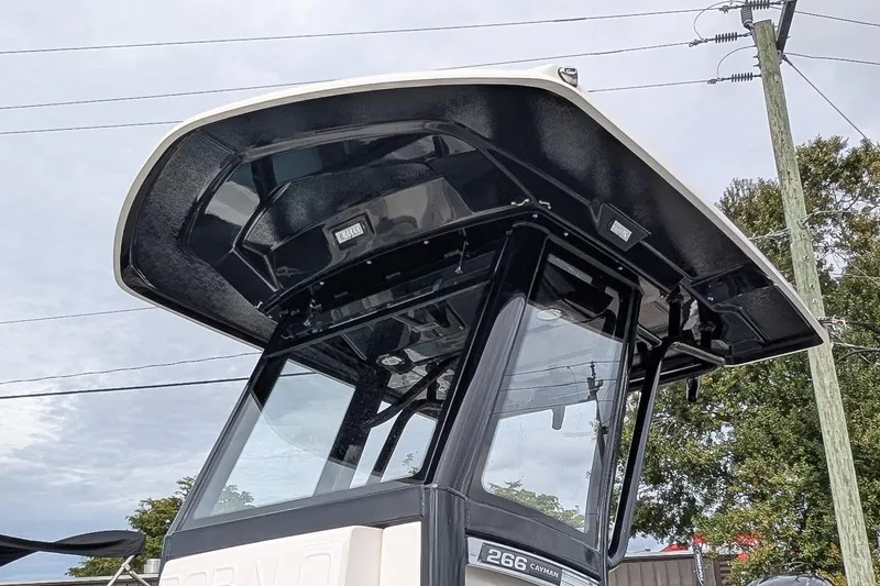 Slide: The Image of 2023 Robalo 266 Cayman boat with sleek black T-top design. - 23