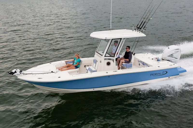 Slide: The Image of Manufacturer Provided Image: 2023 Robalo 266 Cayman boat cruising on water with passengers. - 24