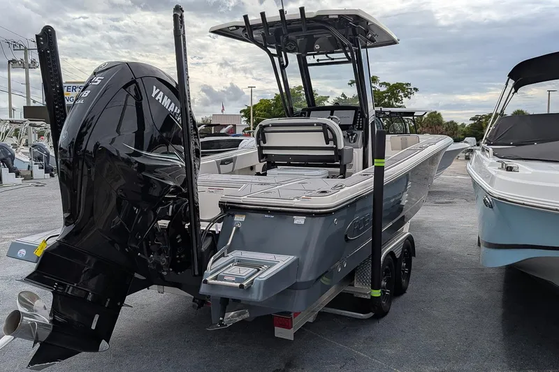Slide: The Image of 2023 Robalo 266 Cayman boat with Yamaha engine, displayed outdoors on a trailer. - 4