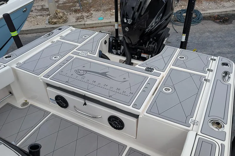 Slide: The Image of 2023 Robalo 266 Cayman boat deck with storage compartments and Yamaha outboard motor. - 8