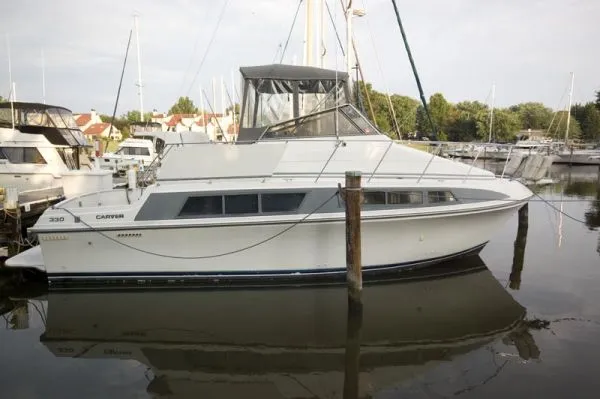 The Image of 1995 Carver 330 Mariner yacht docked in harbor. - 1