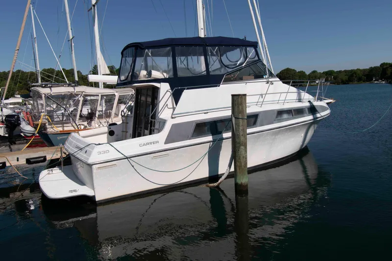 The Image of 1995 Carver 330 Mariner yacht docked in a serene marina setting. - 0