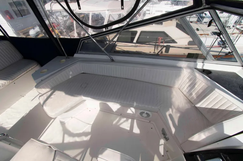Slide: The Image of Interior view of a 1995 Carver 330 Mariner yacht with white seating and windows. - 12