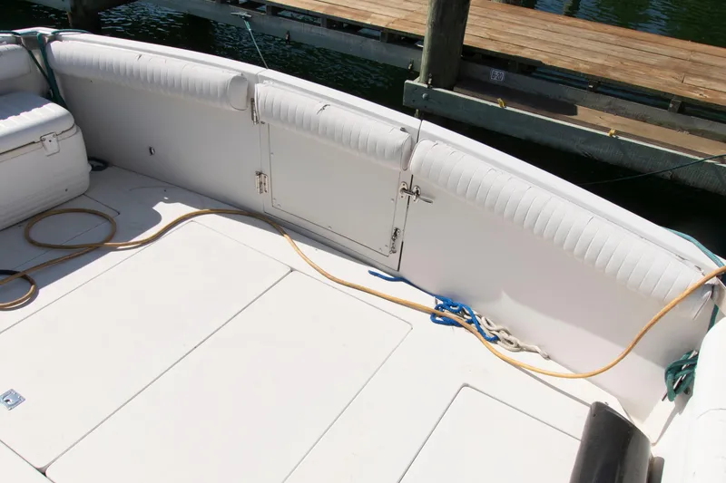 Slide: The Image of 1995 Carver 330 Mariner boat deck with seating and docked at a marina. - 13