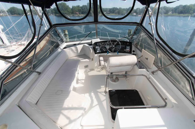 Slide: The Image of Cockpit of 1995 Carver 330 Mariner yacht with seating and steering wheel, overlooking water. - 3