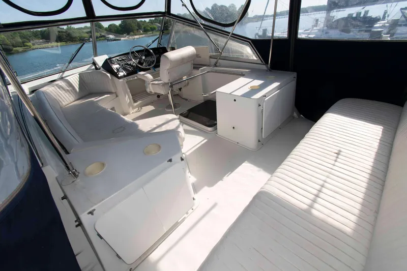 Slide: The Image of Spacious interior of 1995 Carver 330 Mariner yacht with comfortable seating and helm. - 4