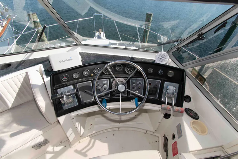 Slide: The Image of Cockpit of 1995 Carver 330 Mariner with steering wheel and Garmin navigation system. - 5