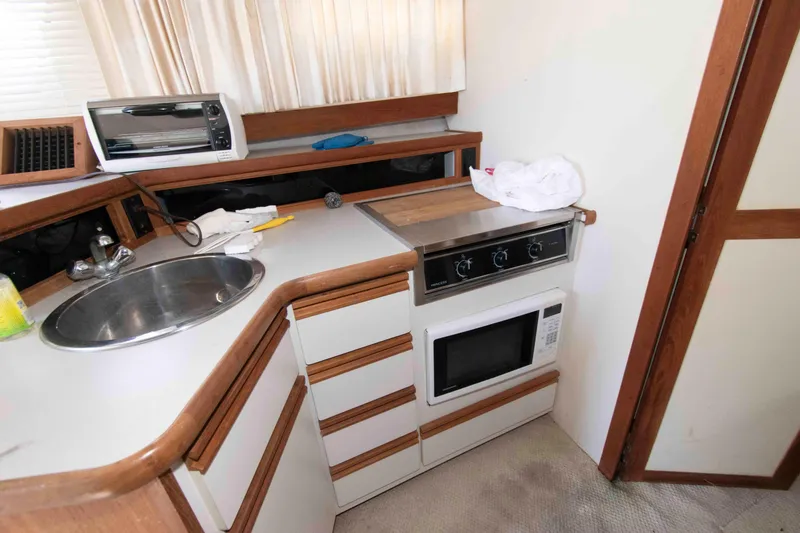 Slide: The Image of Compact kitchen area in a 1995 Carver 330 Mariner yacht with sink and appliances. - 8