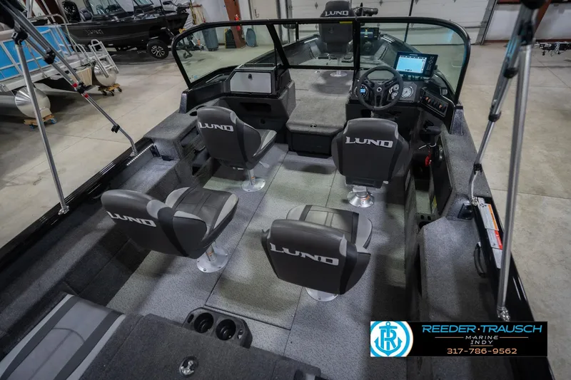Slide: The Image of 2026 Lund 2075 Impact XS boat interior with four seats and steering console. - 14