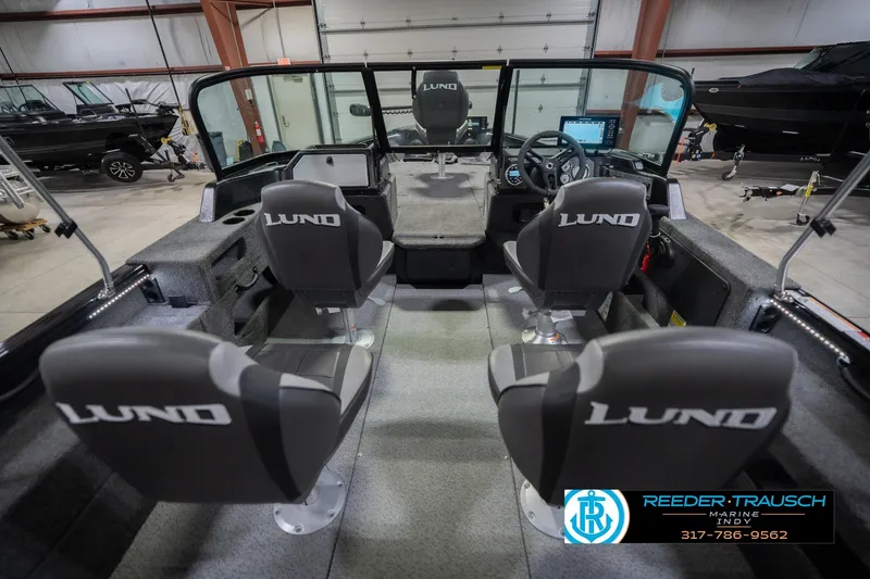 Slide: The Image of 2026 Lund 2075 Impact XS boat interior with four seats in a showroom. - 16
