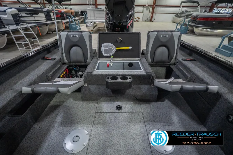 Slide: The Image of 2026 Lund 2075 Impact XS boat interior with seating and storage compartments. - 25