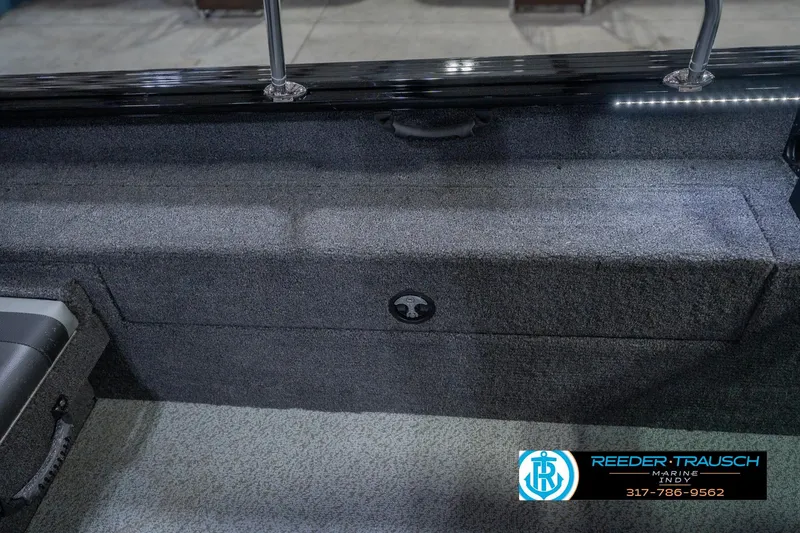 Slide: The Image of 2026 Lund 2075 Impact XS boat interior with storage compartment and seating. - 26