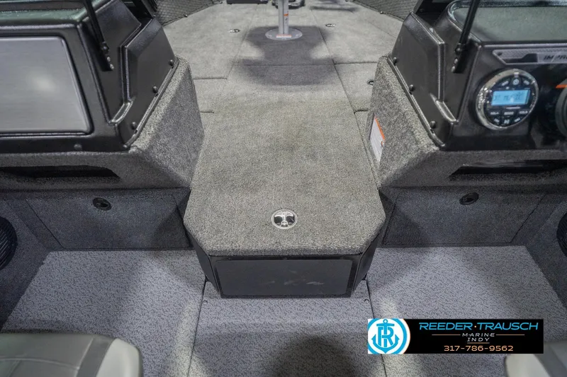Slide: The Image of Interior of 2026 Lund 2075 Impact XS boat, featuring carpeted flooring and control panel. - 28
