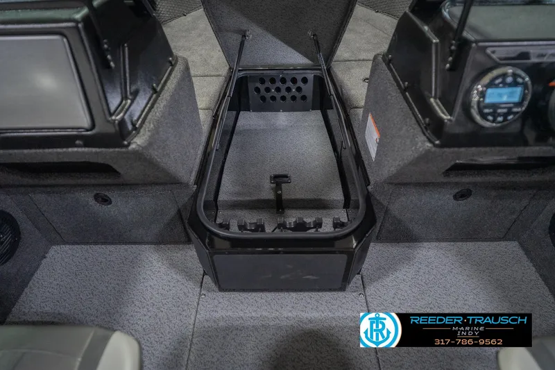 Slide: The Image of 2026 Lund 2075 Impact XS boat interior with storage compartment and control panel. - 29