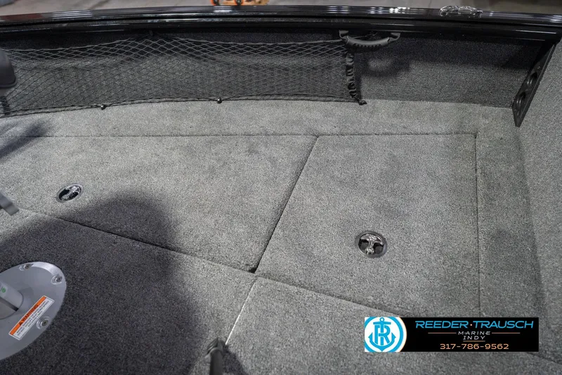 Slide: The Image of 2026 Lund 2075 Impact XS boat interior with carpeted flooring and storage compartments. - 30