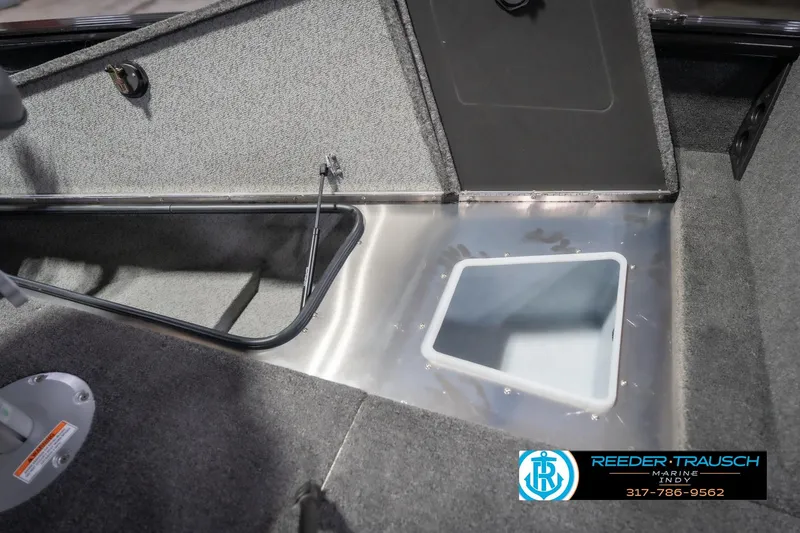 Slide: The Image of 2026 Lund 2075 Impact XS boat interior with storage compartment and carpeted flooring. - 31