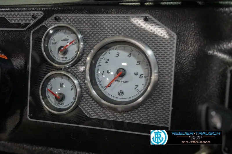 Slide: The Image of Dashboard gauges of 2026 Lund 2075 Impact XS boat, featuring trim, RPM, and fuel indicators. - 37