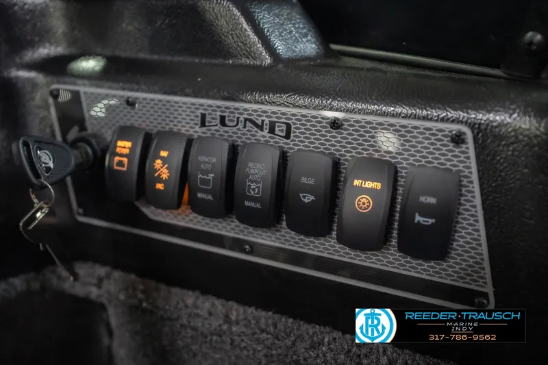 Slide: The Image of Control panel of 2026 Lund 2075 Impact XS boat with illuminated switches. - 38