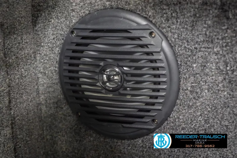 Slide: The Image of Speaker grill on 2026 Lund 2075 Impact XS boat interior, gray carpeted surface. - 46