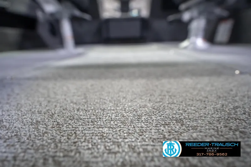 Slide: The Image of 2026 Lund 2075 Impact XS boat interior with carpet flooring, Reeder-Trausch Marine logo visible. - 48