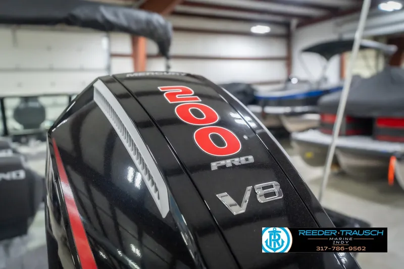 Slide: The Image of Close-up of a 2026 Lund 2075 Impact XS boat's 200 Pro V8 engine in a showroom. - 51