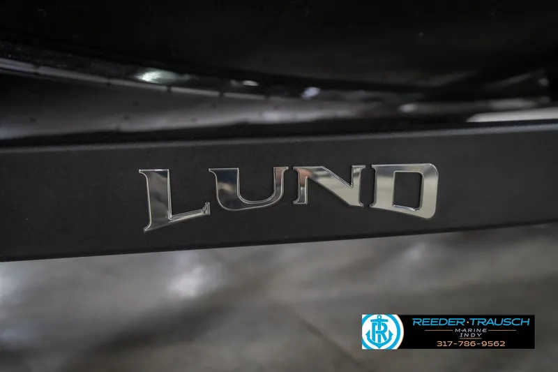 Slide: The Image of 2026 Lund 2075 Impact XS boat logo on black surface, Reeder Trausch Marine contact info visible. - 62