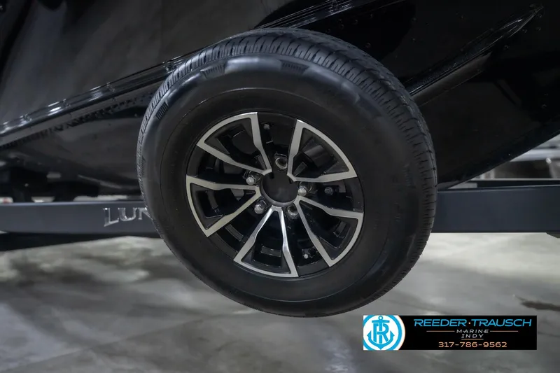 Slide: The Image of 2026 Lund 2075 Impact XS trailer wheel, black alloy rim, Reeder Trausch Marine logo. - 63