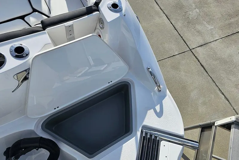 Slide: The Image of 2026 Stingray 211 DC boat interior with storage compartment and seating area. - 12