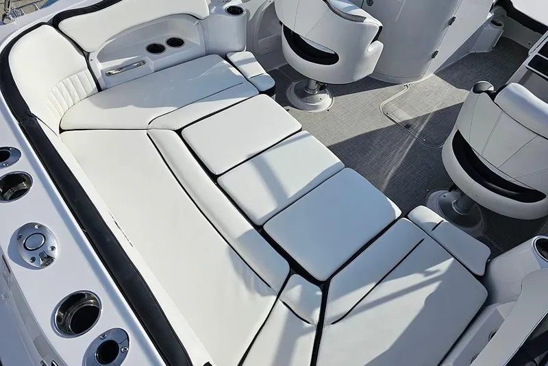 Slide: The Image of 2026 Stingray 211 DC boat interior with white cushioned seating and modern design. - 13