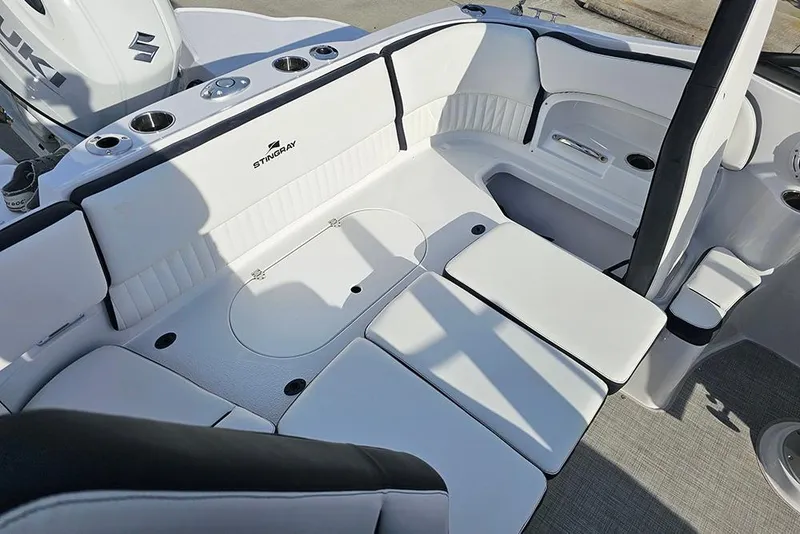 Slide: The Image of 2026 Stingray 211 DC boat interior with white seating and cup holders. - 17