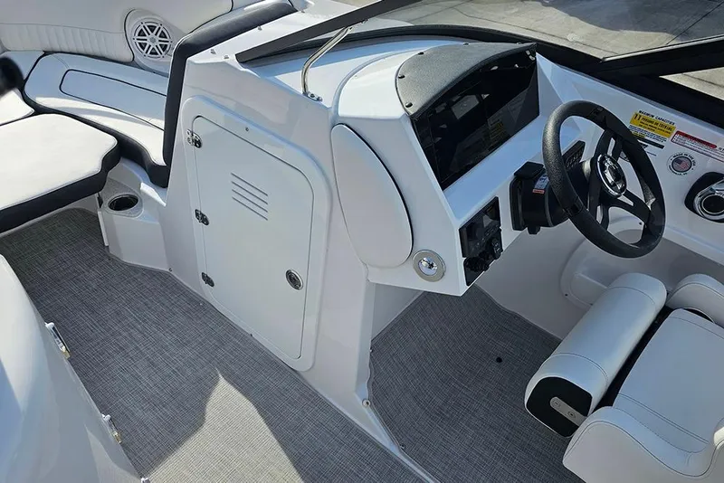 Slide: The Image of Interior of 2026 Stingray 211 DC boat, featuring sleek dashboard and seating. - 24