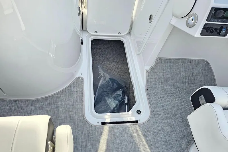 Slide: The Image of Interior view of 2026 Stingray 211 DC boat, featuring storage compartment and seating. - 27