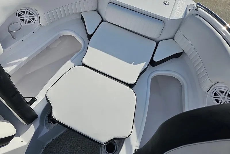 Slide: The Image of Interior seating of 2026 Stingray 211 DC boat, featuring white cushioned seats. - 29
