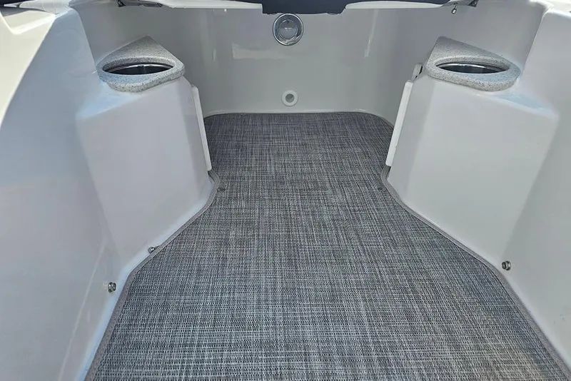 Slide: The Image of Interior of 2026 Stingray 211 DC boat with carpeted flooring and cup holders. - 30