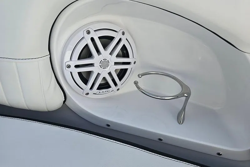 Slide: The Image of 2026 Stingray 211 DC boat interior with JL Audio speaker and stainless steel cup holder. - 31