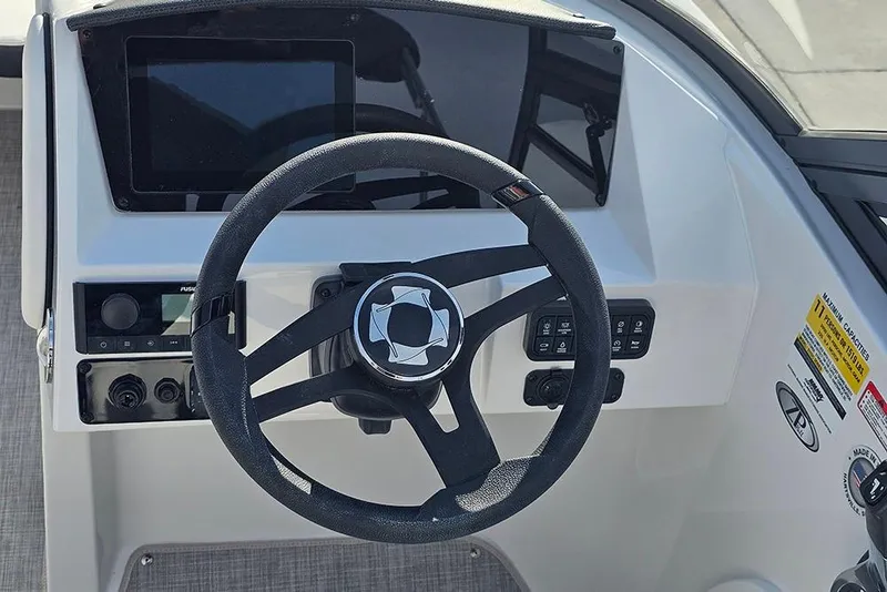 Slide: The Image of Steering wheel and dashboard of 2026 Stingray 211 DC boat, featuring modern controls. - 35