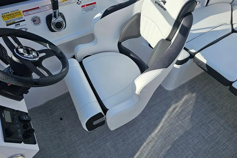Slide: The Image of 2026 Stingray 211 DC boat interior with steering wheel and seating. - 36