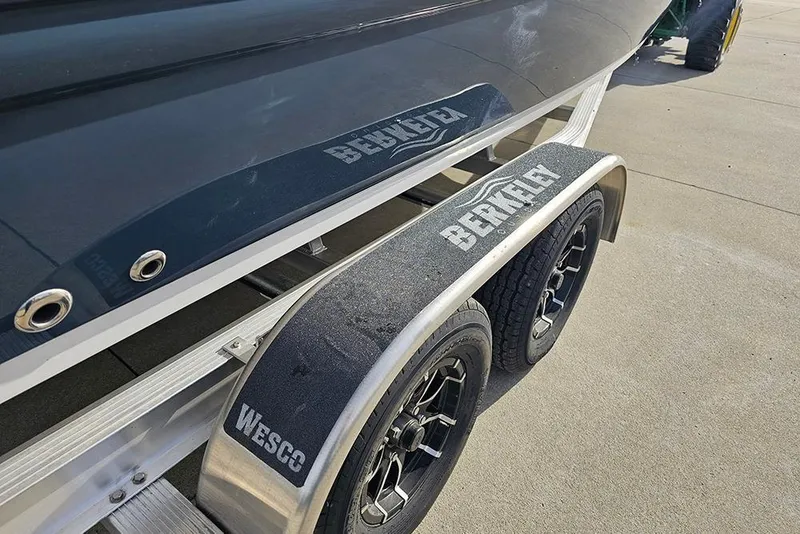 Slide: The Image of 2026 Stingray 211 DC boat on trailer with Berkley branding and Wesco wheels. - 4