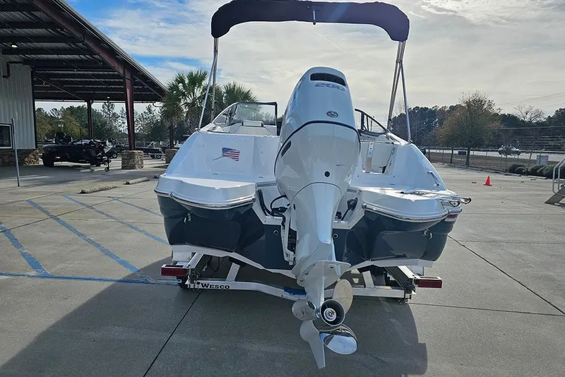 Slide: The Image of 2026 Stingray 211 DC boat on trailer, rear view with outboard motor. - 9