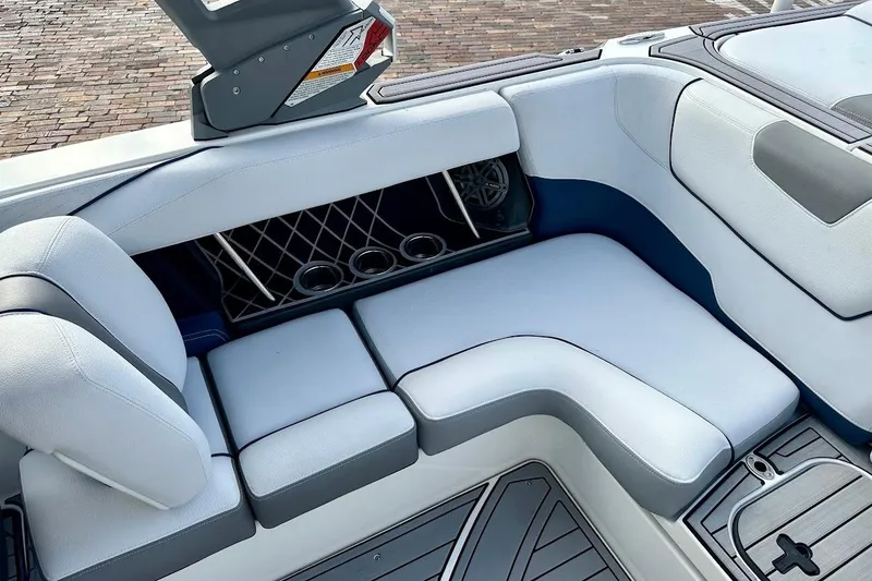 Slide: The Image of Interior seating of 2018 Correct Craft Super Air Nautique GS22 boat, featuring cup holders. - 23