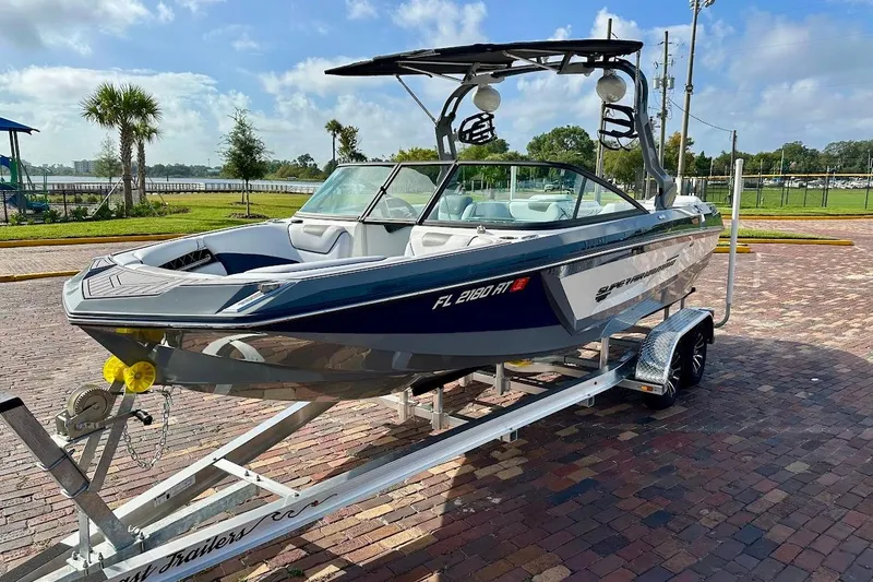 Slide: The Image of 2018 Correct Craft Super Air Nautique GS22 boat on trailer, parked outdoors. - 4