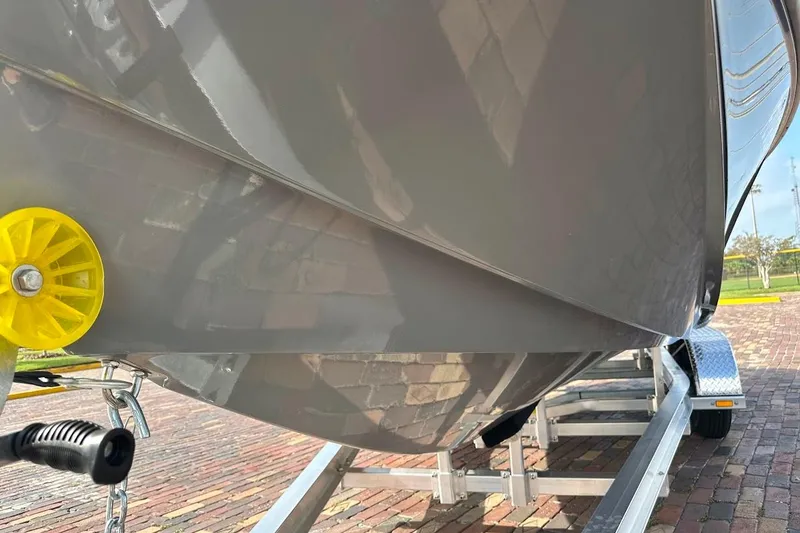 Slide: The Image of 2018 Correct Craft Super Air Nautique GS22 boat hull on trailer, close-up view. - 5