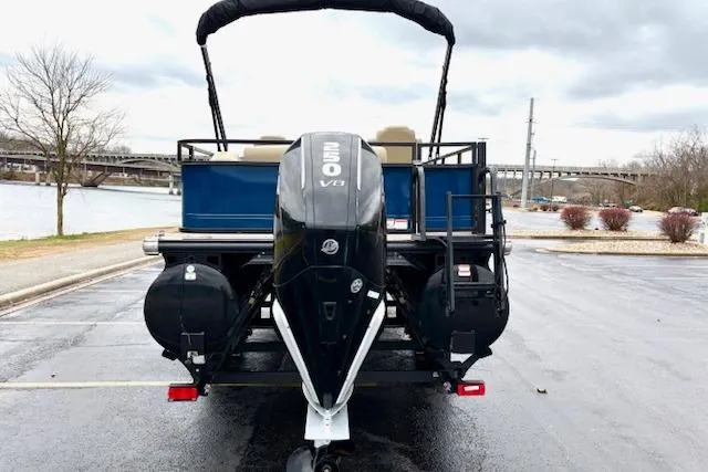Slide: The Image of 2025 Regency 250 DL3 pontoon boat with powerful V8 engine, parked near a river. - 11