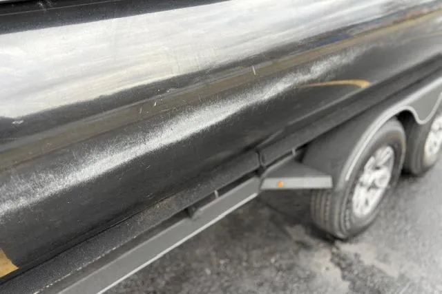 Slide: The Image of 2025 Regency 250 DL3 boat on trailer, showing side detail and wheels. - 18