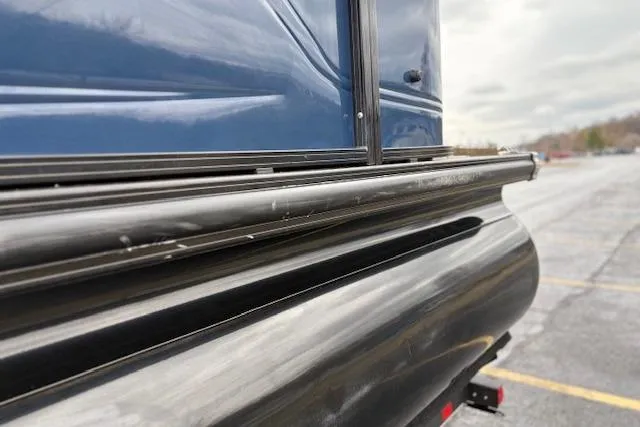 Slide: The Image of Close-up of 2025 Regency 250 DL3 boat exterior detailing in a parking lot. - 20